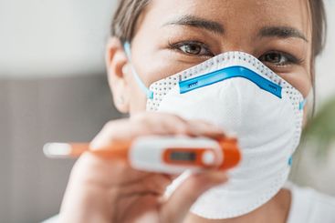 Woman, mask and thermometer for covid, quarantine and...