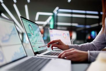 Young Caucasian woman analyzing business KPI data