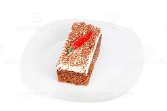 Piece of cake on a plate, and the fruit of paprika.
