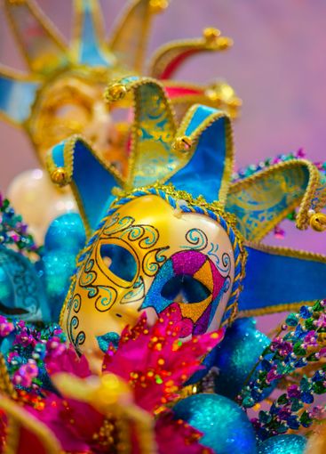 Carnival background with masks, feathers and...