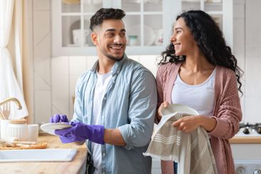 Cheerful Middle Eastern Couple Sharing Domestic Chores,...