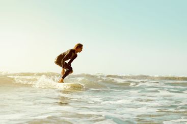 Sea, surfing and blue sky mockup with a man on his...