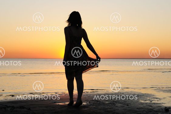 Woman as silhouette by the sea