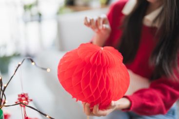 Asian Woman decorated house for Chinese New Year...