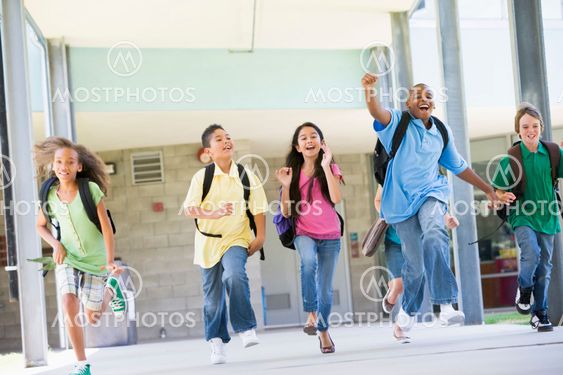 Elementary school pupils running outside
