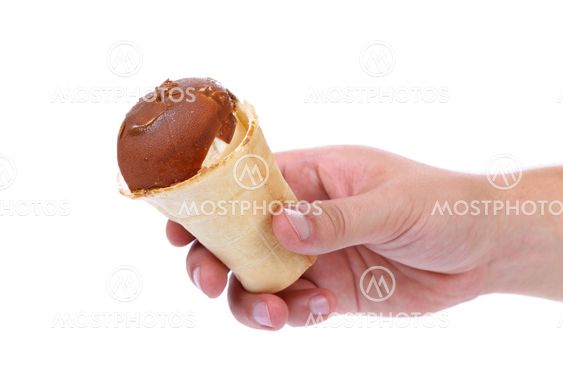Hand holds waffle cup of chocolate ice cream