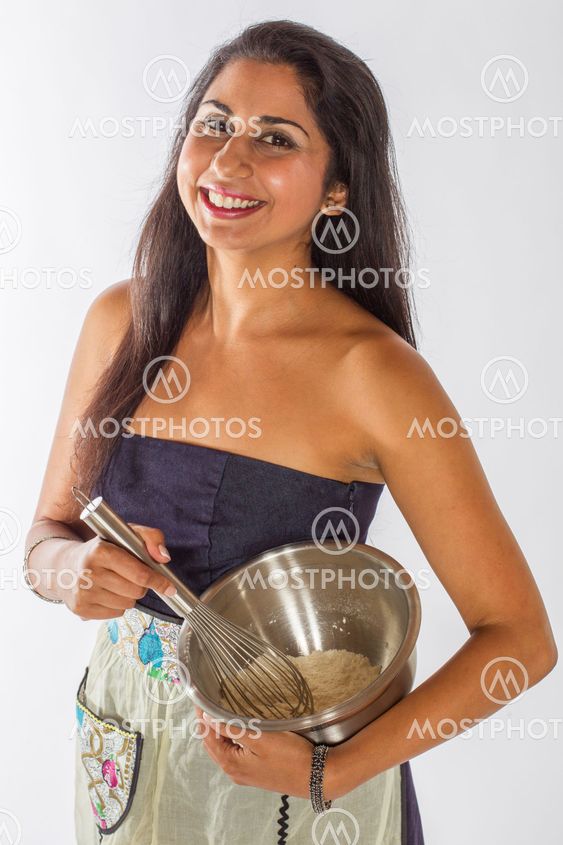 Smiling Indian Woman Mixing Cake