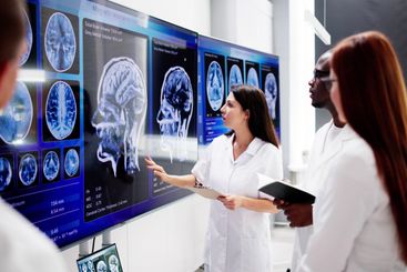 Doctors In Clinic Looking At Brain MRI Scan