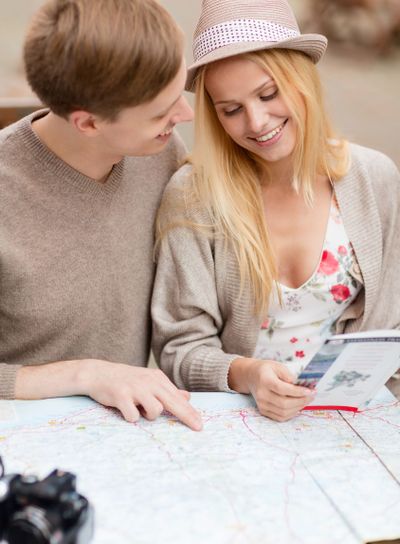 couple with map, camera and travellers guide