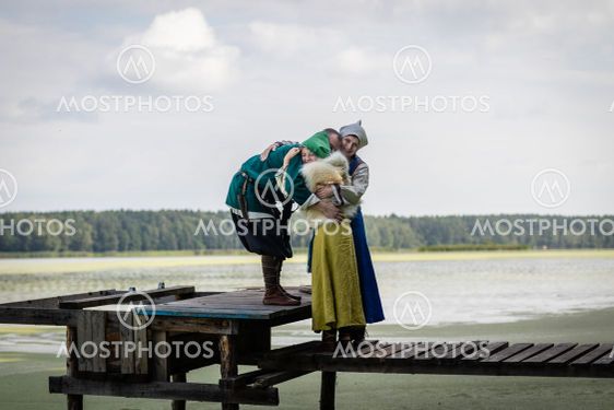 Viking family hugging on the footbridge by the lake