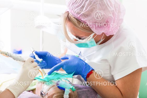 female dentist treat teeth