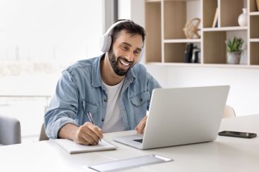Man take part in online class using laptop and application