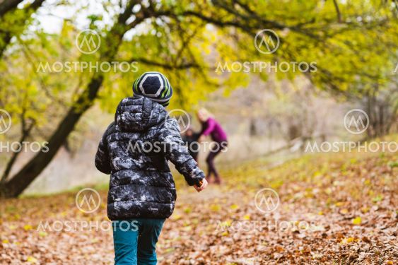 Back of boy playing with family outdoors