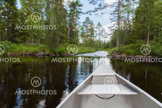 An aluminum canoe near whitewater