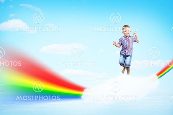 boy jumping on clouds and a rainbow