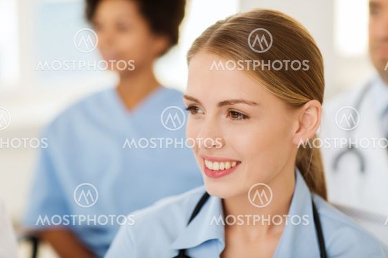 happy doctor over group of medics at hospital