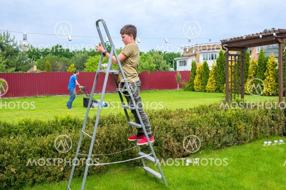 Garden work. A boy with his father are working in the...