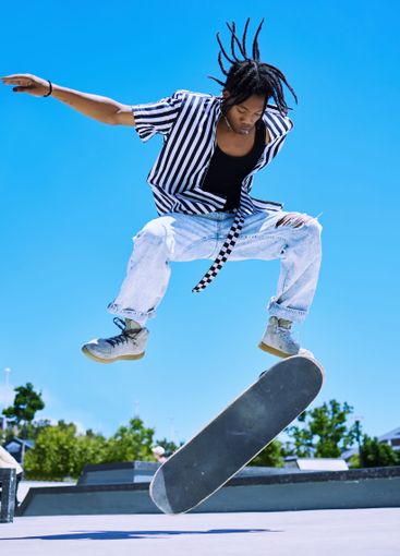 Skateboard, park and black man with jump in air for fun...