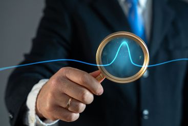 A businessman studies an abnormal jump on a chart. Sales...