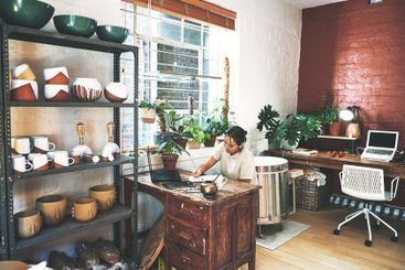Pottery, book or woman with writing in workshop for...