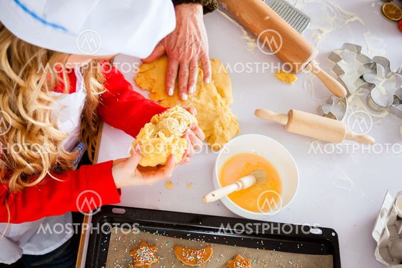 Family baking Christmas cookies in kitchen