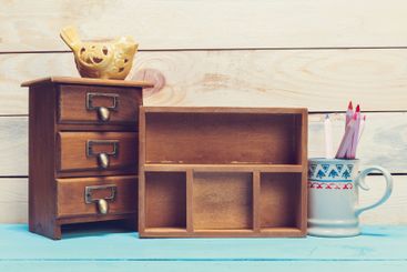 Cozy pastel wooden home decor objects on blue background