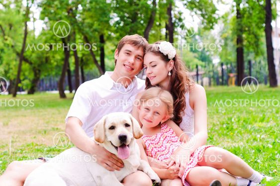 Happy young family with Labrador