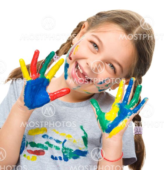 Portrait of a cute girl playing with paints
