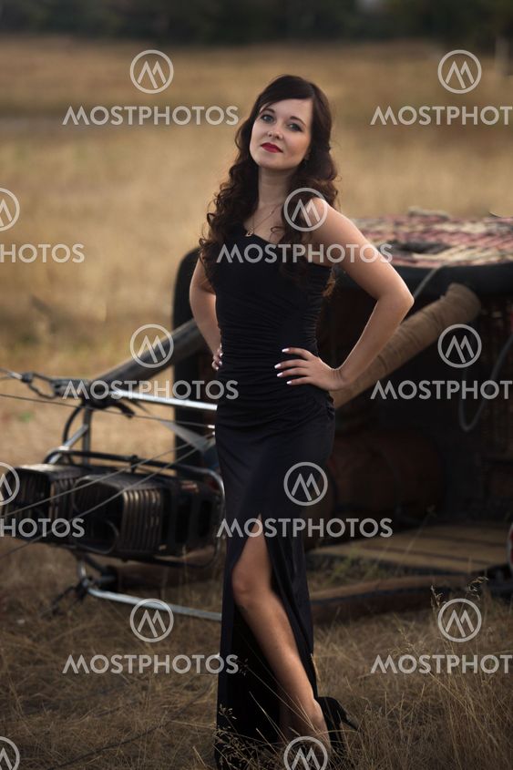 sexy woman in black dress posing at the balloon wicker...