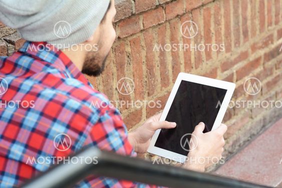 latin man using a tablet.