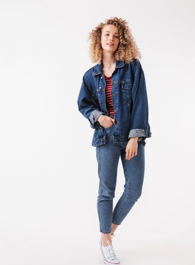 Full length image of Pretty curly woman in denim clothes