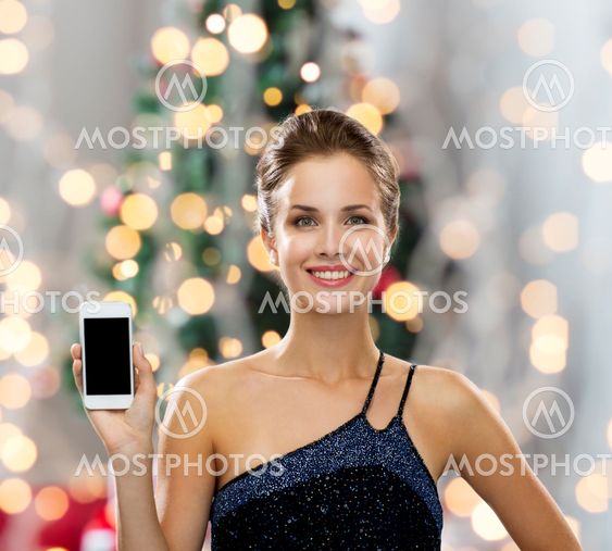 smiling woman in evening dress with smartphone
