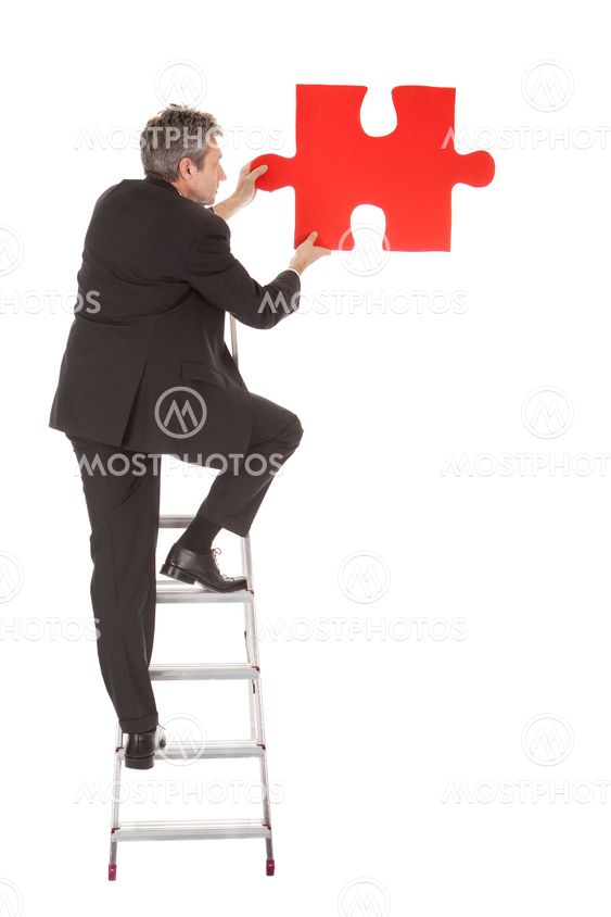 Senior businessman holding a jigsaw puzzle