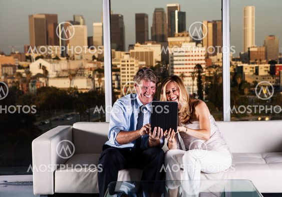 Mature couple at night working with skyline