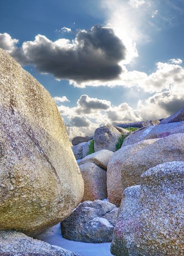 Clouds, formation and beach by sky with rocks, scenic...