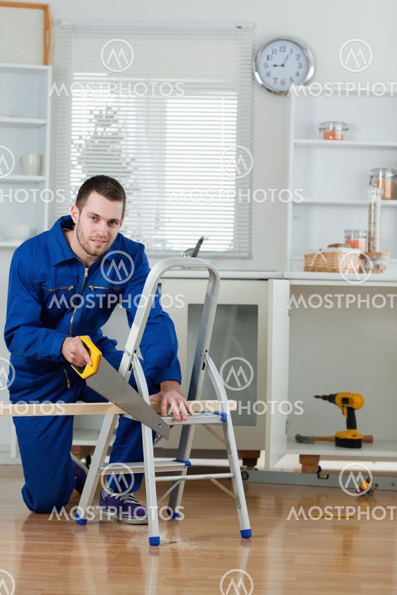 Portrait of a handyman cutting a wooden board