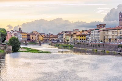 Daylight view to sunset above Arno river with reflections