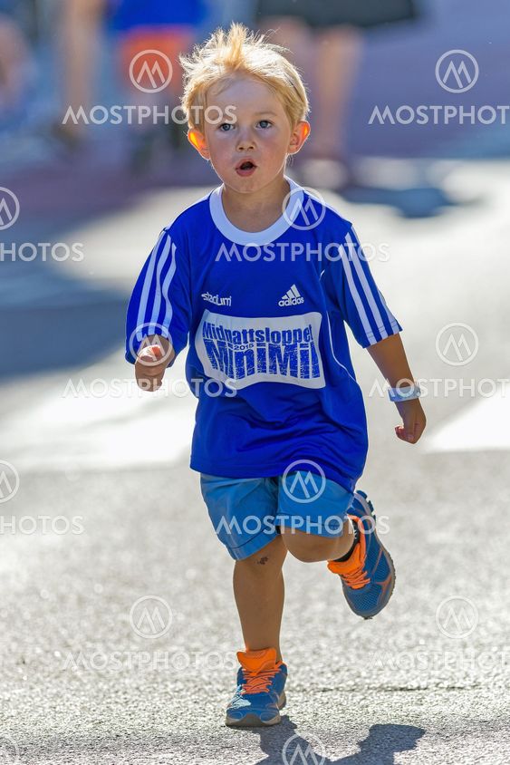 Young boy with big blue shirt at the final 50 meters at...