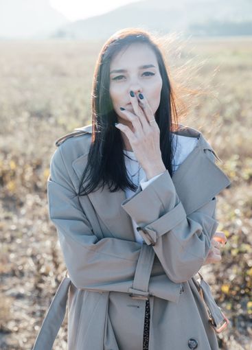 Beautiful fashionable brunette woman in gray coat...