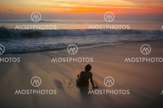 Waves rolling towards a boy
