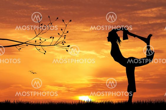 woman doing yoga at sunset