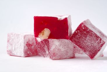 Traditional Turkish delight cubes displayed on a white...