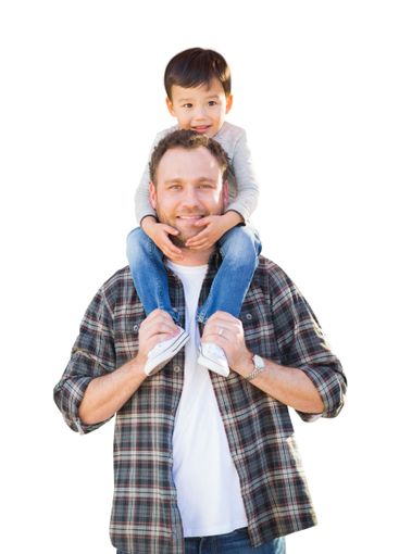 Happy Mixed Race Father and Son Riding Piggyback...