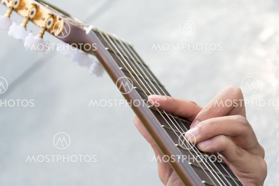 hand playing on guitar