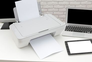Modern printer in a home office setting printing...