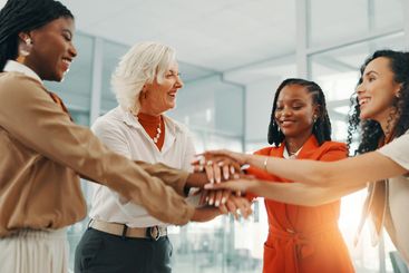 Hands together, teamwork and support with business women...