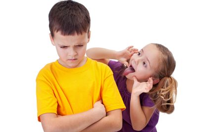 Young girl mocking boy - isolated