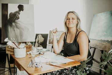 Drawing, painting and portrait of woman in studio at...