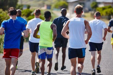 Group, fitness and men with running in road for marathon...