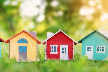 Several colourful houses models standing on the green...